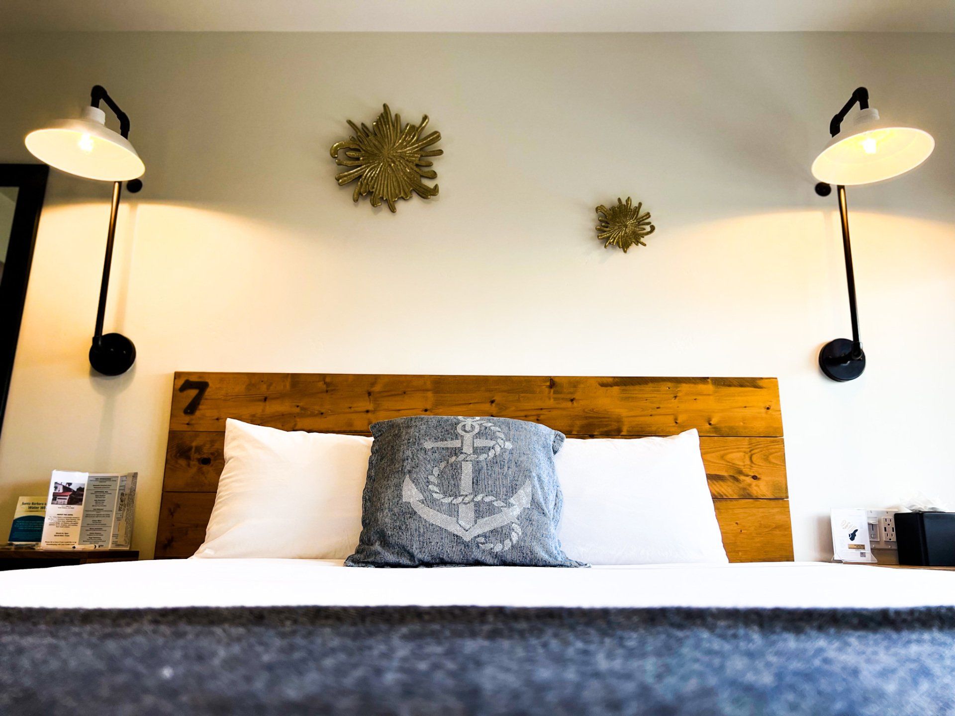 King Size Bed with two white pillows and, one gray pillow with an anchor print.