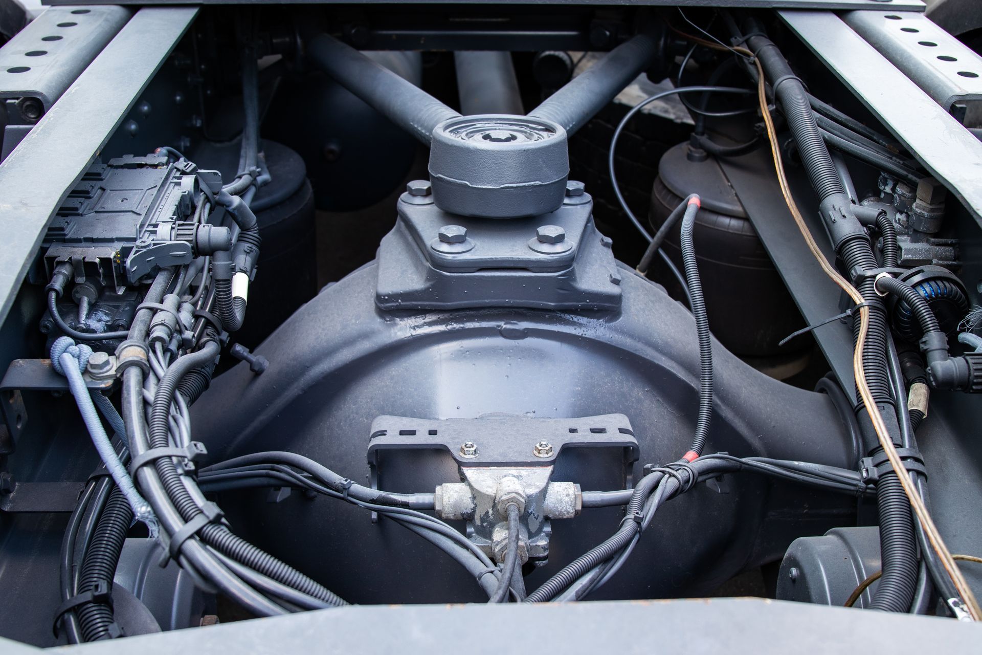 Detail-rich image of a truck's rear frame, showcasing the pneumatic system & rear axle suspension.