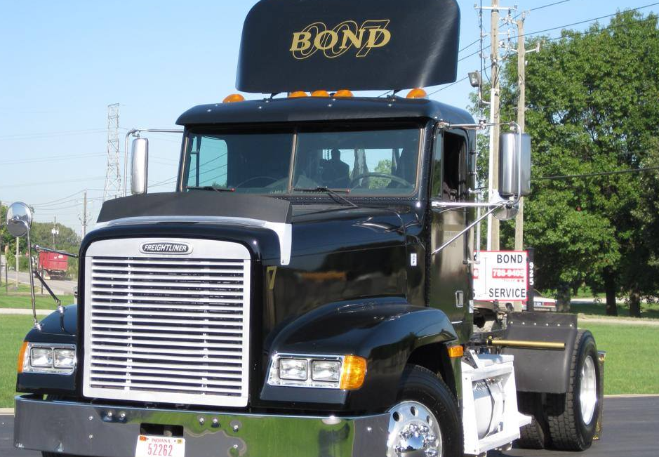 A black Freightliner semi-truck with a