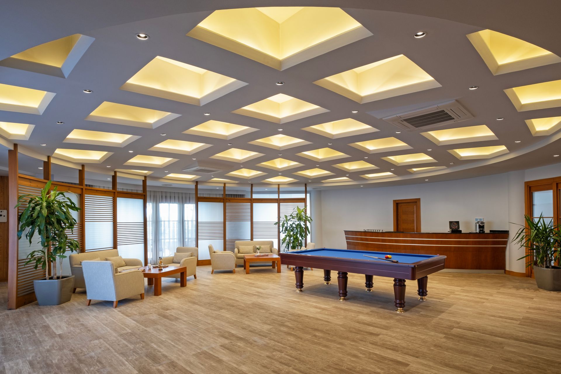A pool table is in the middle of a large room