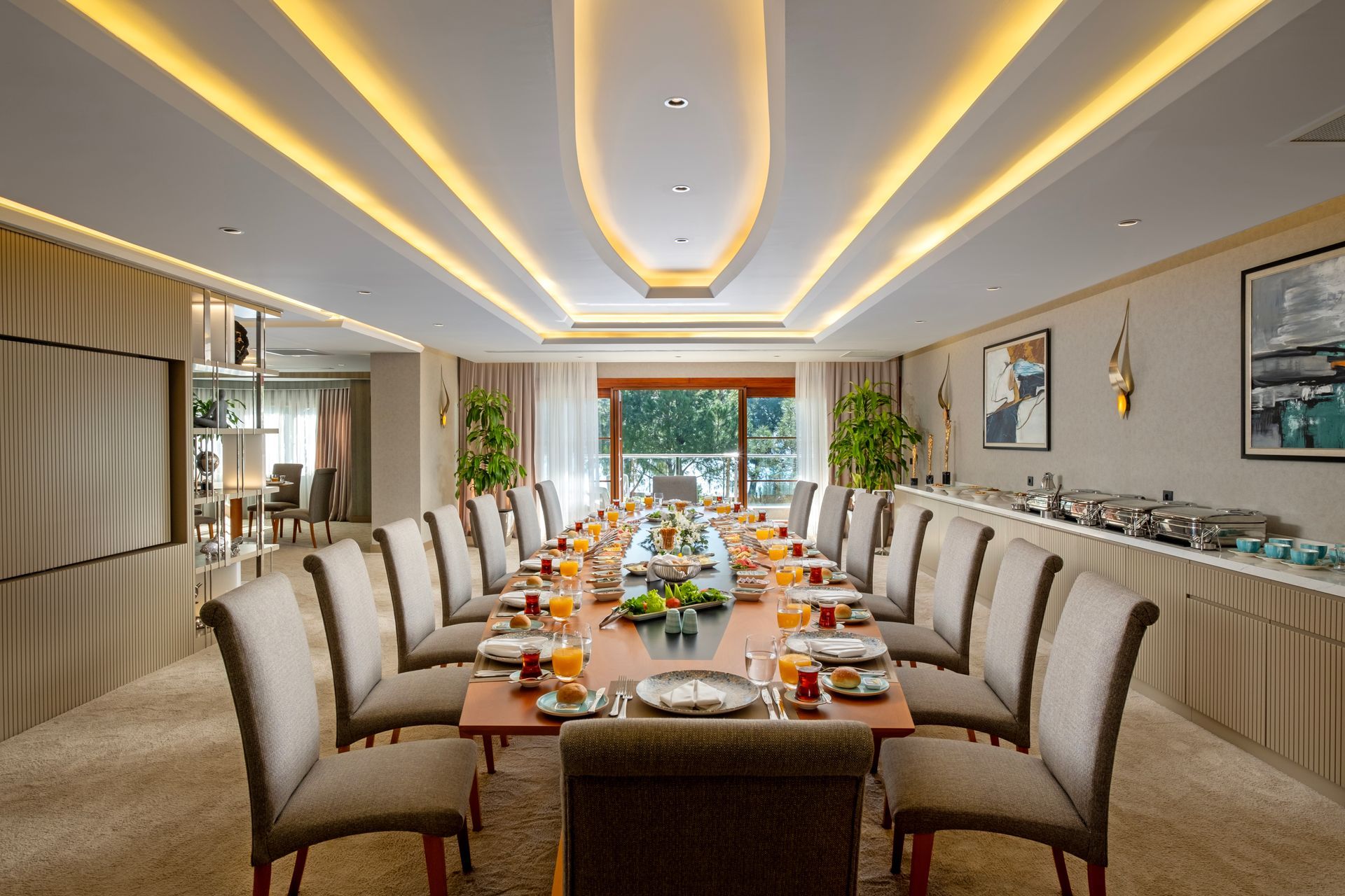 A large dining room with a long table and chairs