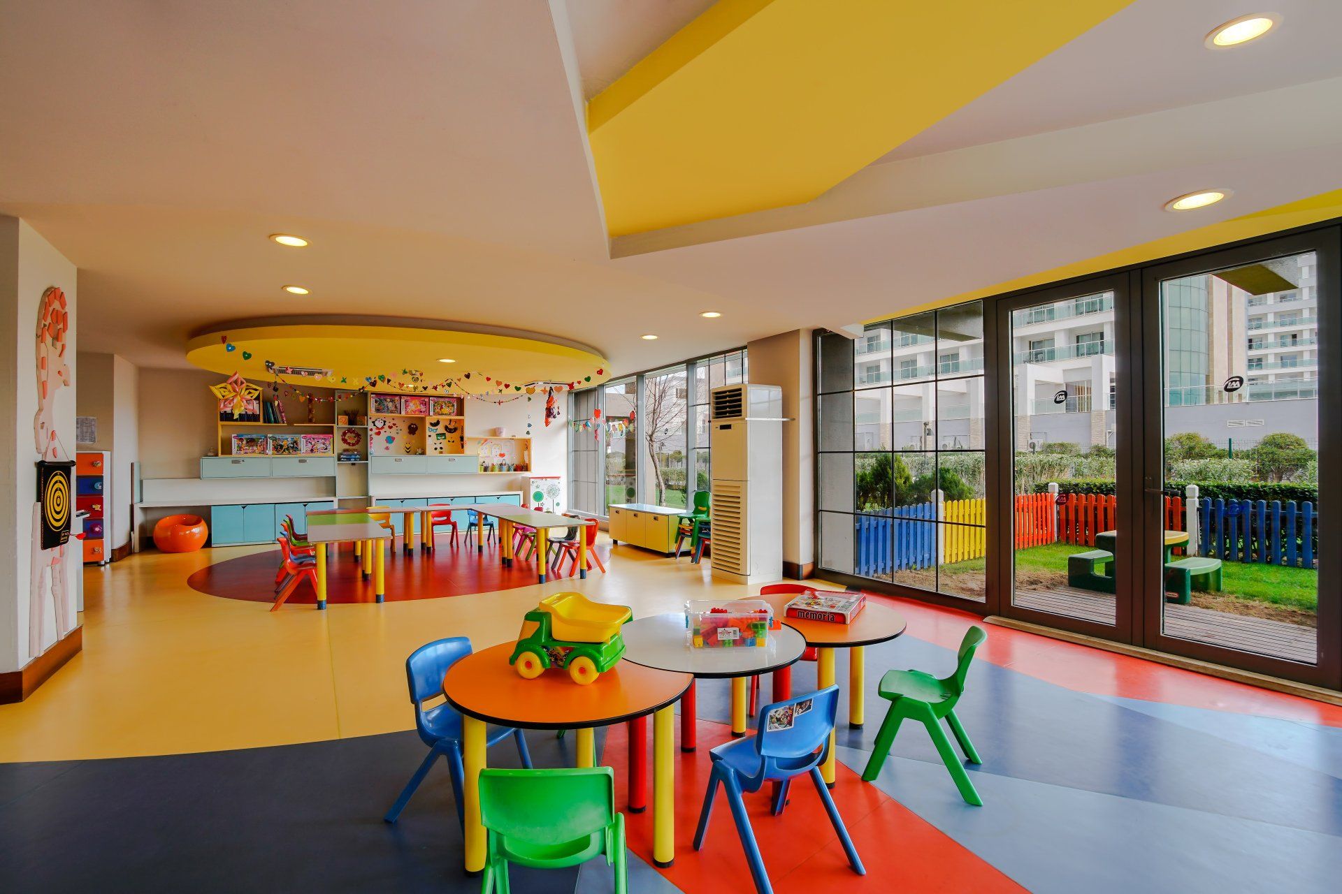 A large room with tables and chairs in it.