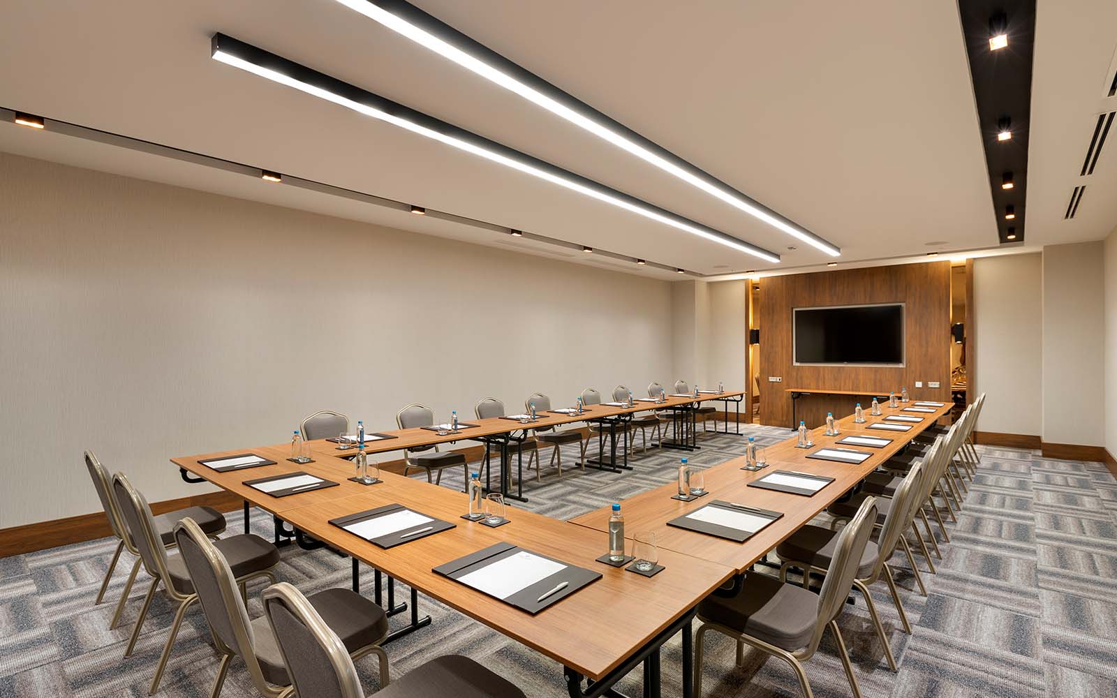 A large conference room with a long table and chairs.
