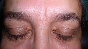A close up of a woman 's face with her eyes closed.