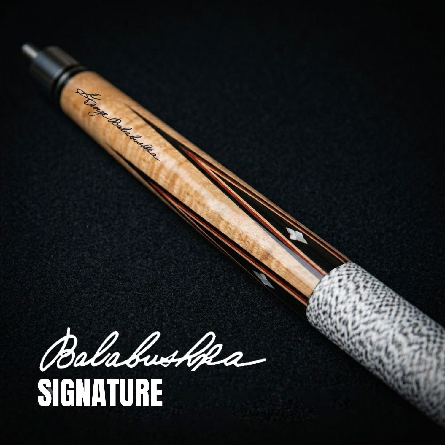 GB3 billiard cue close-up showing Balabushka signature engraving, birdseye maple forearm, and detailed veneer craftsmanship