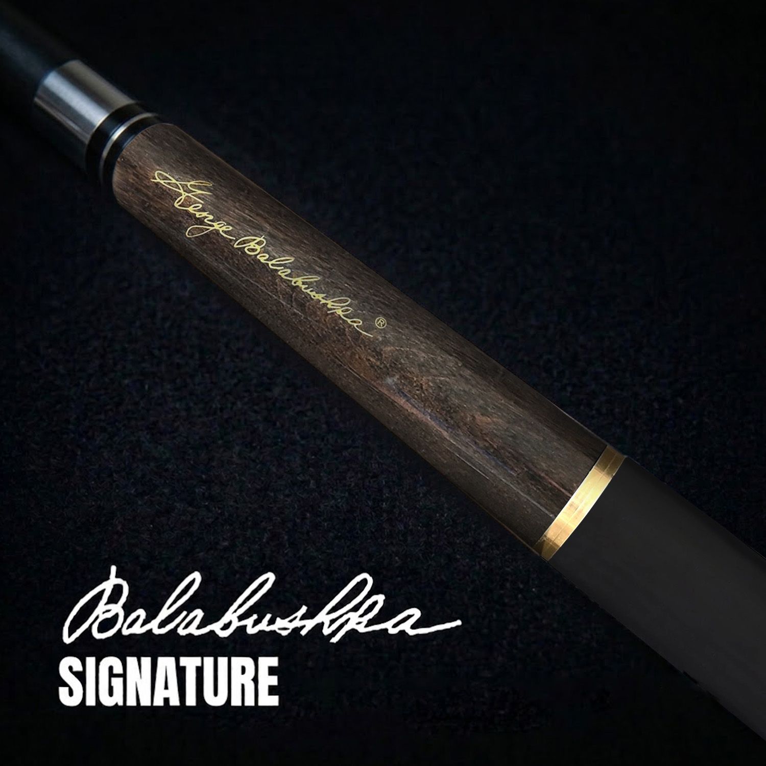 GBJBK-2 break/jump cue close-up showing George Balabushka signature, dark birdseye maple forearm grain, black finish, textured wrap, and elegant gold accent detailing