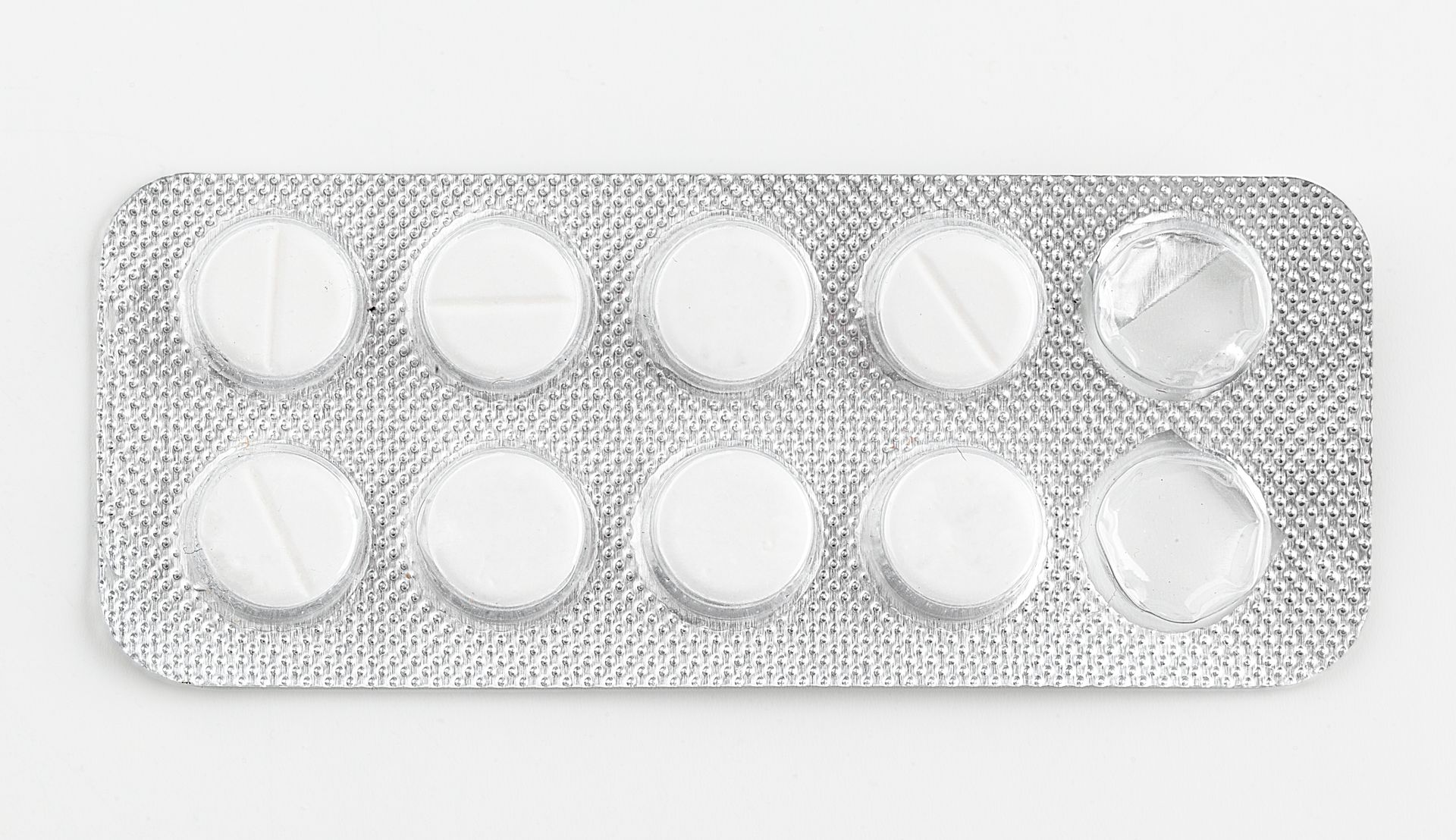 A silver blister pack of pills on a white background, showcasing packaging and sealing solutions.
