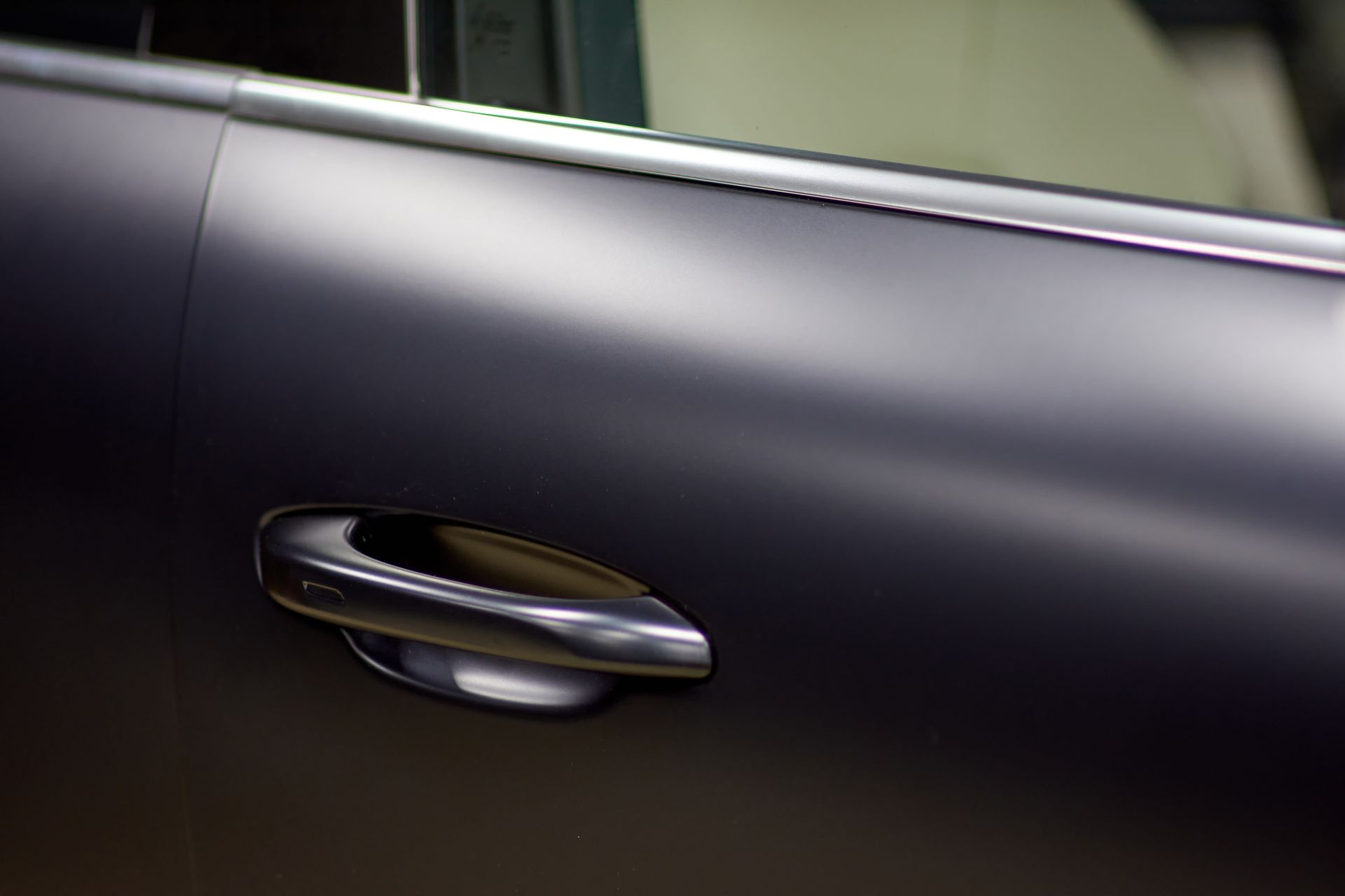 A close up of a door handle on a car.