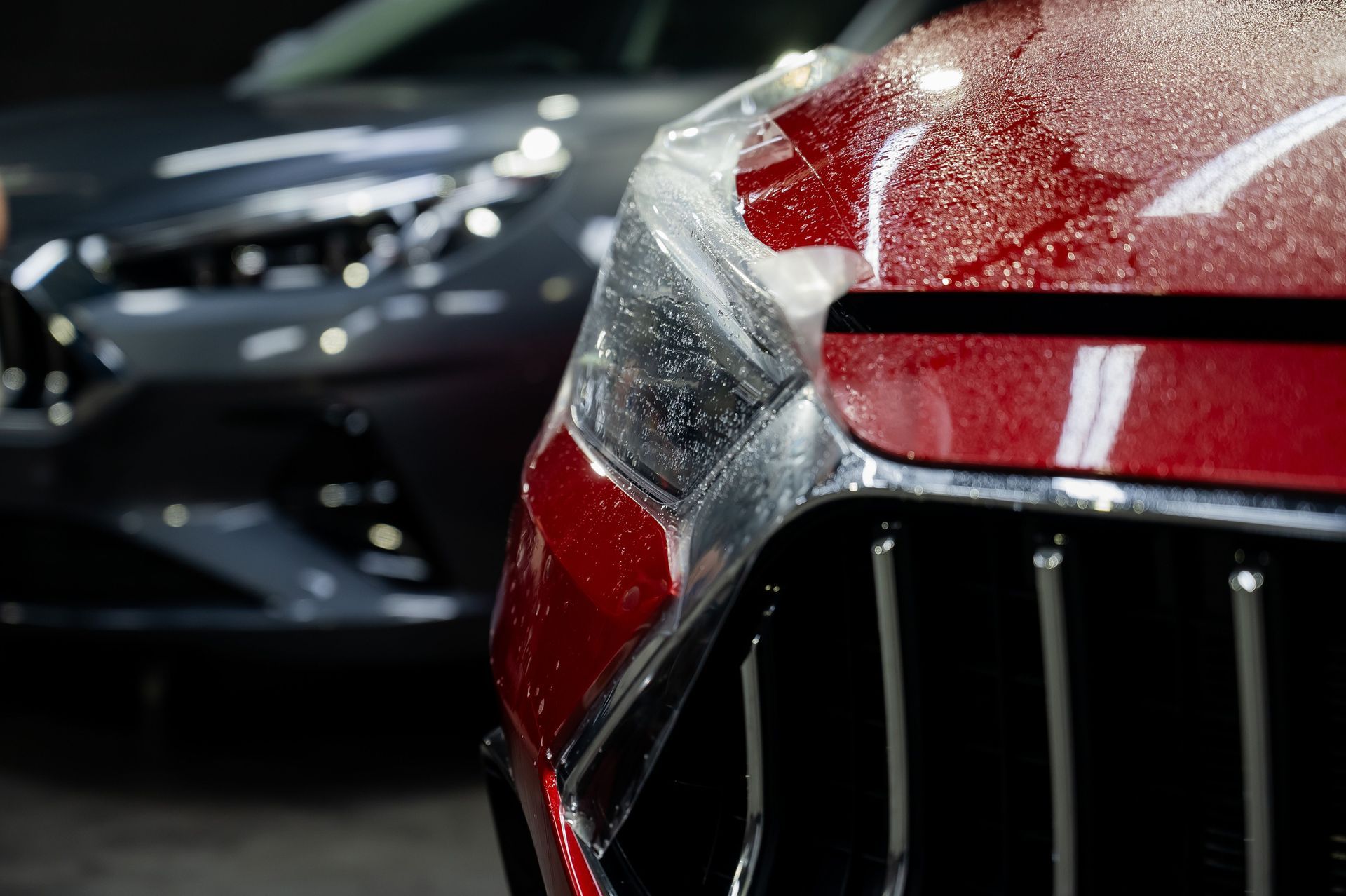 A close up of a car with a protective film on it.