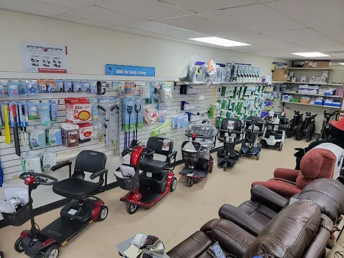 Mobility scooter and lift chair showroom with rows of medical equipment and recliners