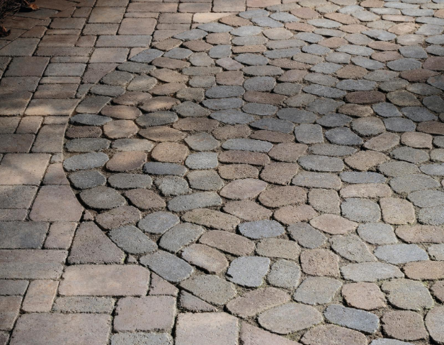“Close-up of textured concrete pavers laid in a rounded stone pattern during concrete services in Pine Hills, FL”