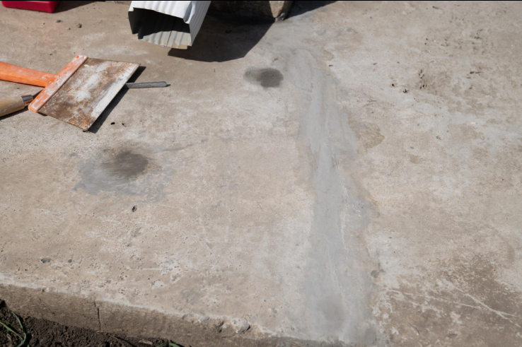 “Concrete floor with a repaired crack and patched surface area during concrete services in Pine Hills, FL”