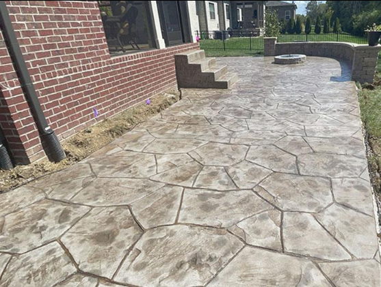 “Stamped concrete walkway with a decorative pattern leading to brick steps during concrete services in Pine Hills, FL”