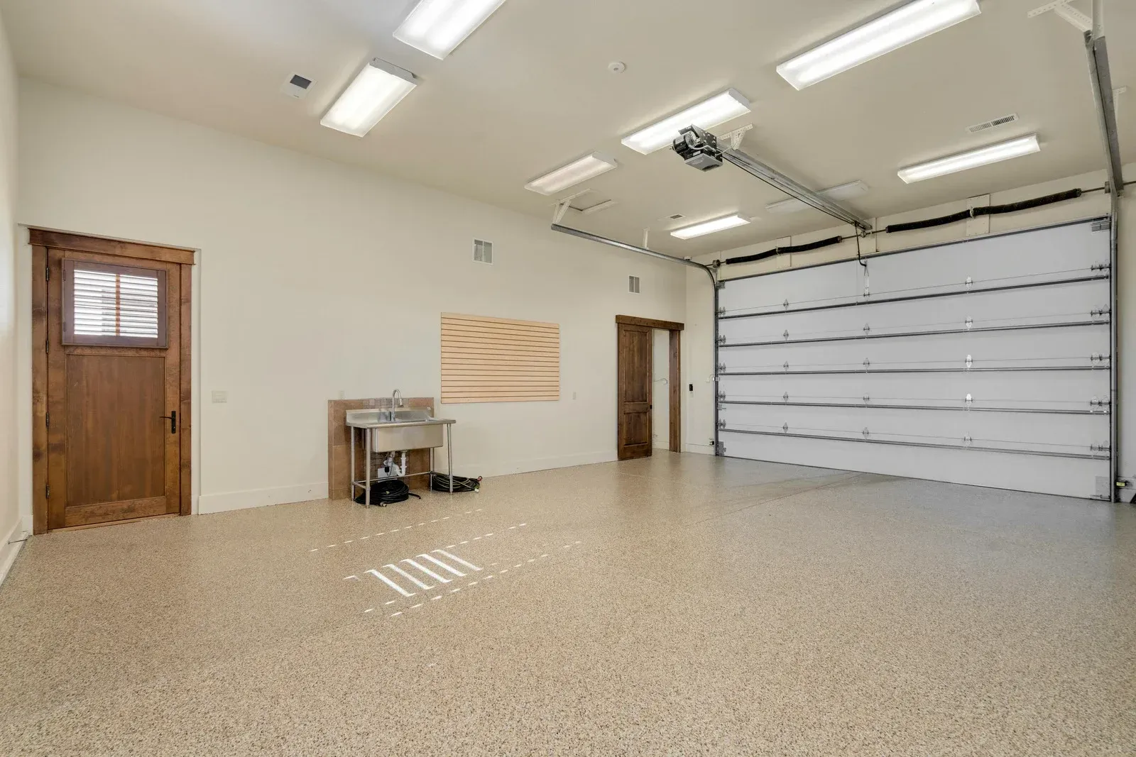 Garage converted into a living space with couch, table, and counter.