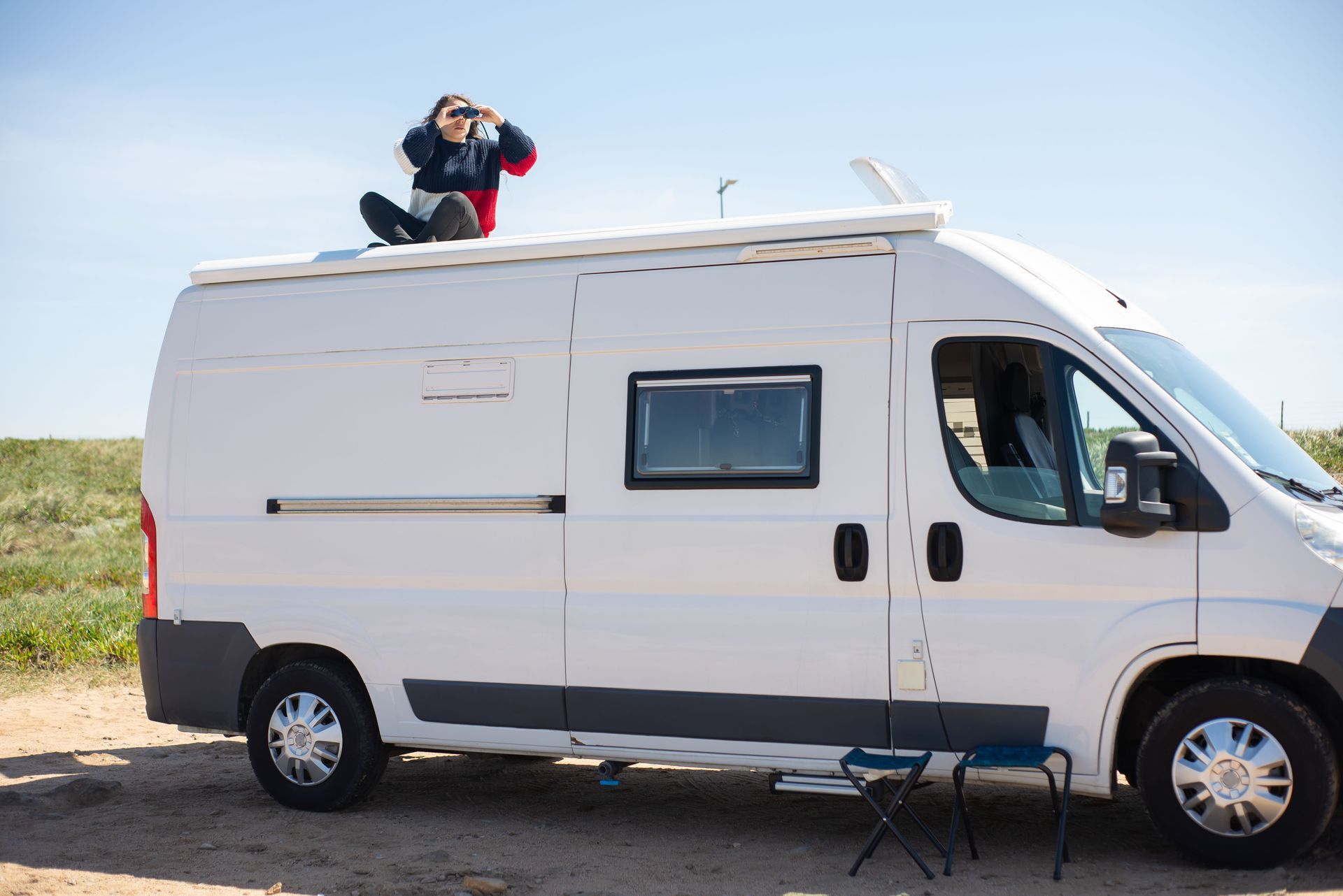 Owner checking the roof of an RV parked in a Hollywood FL driveway