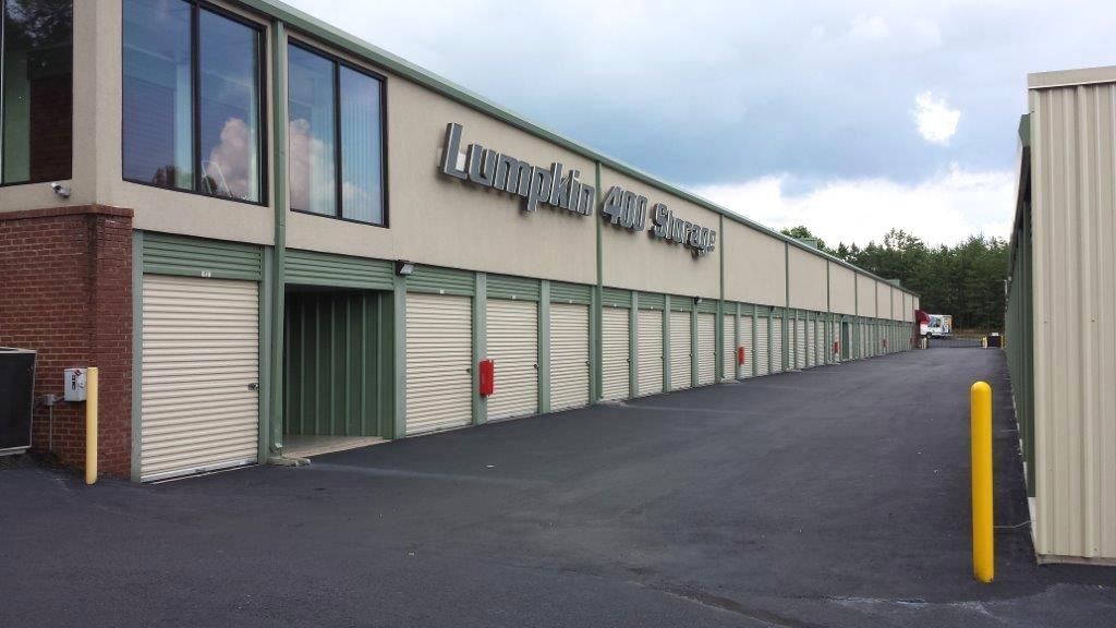 a large warehouse with a lot of wooden pallets in front of it .