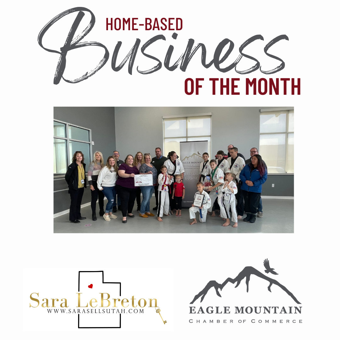 A group of people are posing for a picture in front of a sign that says home based business of the month.