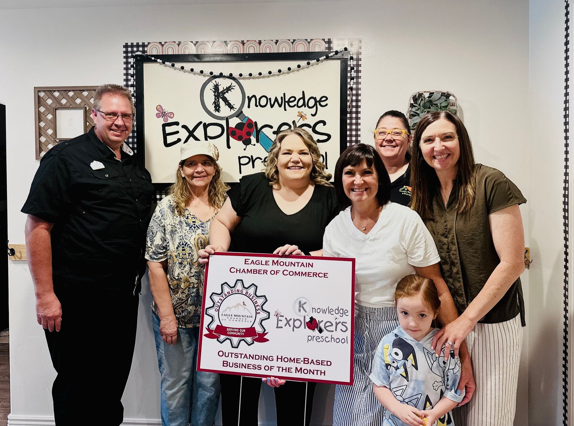 A group of people standing in front of a sign that says knowledge express