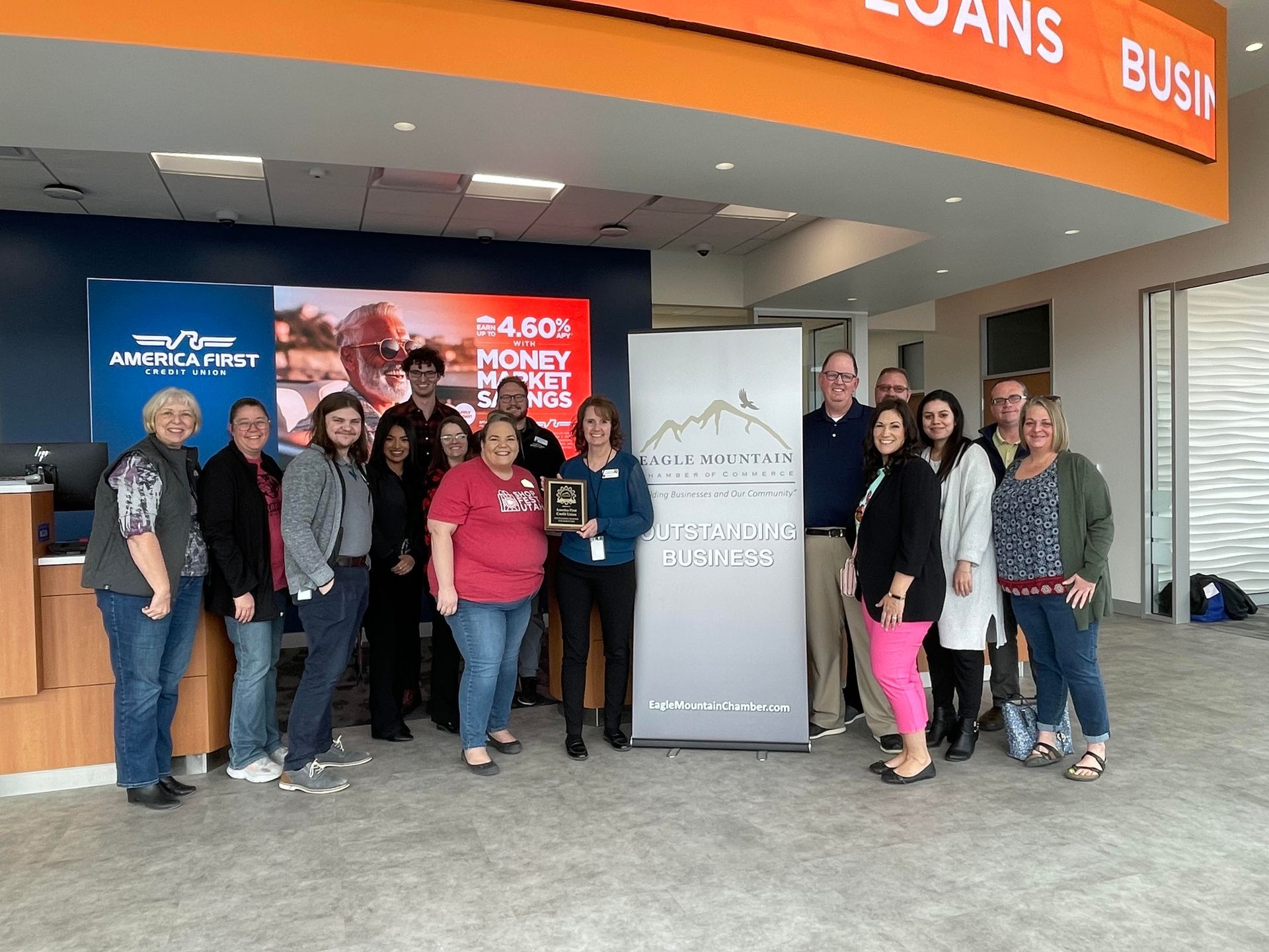 A group of people standing in front of a sign that says loans
