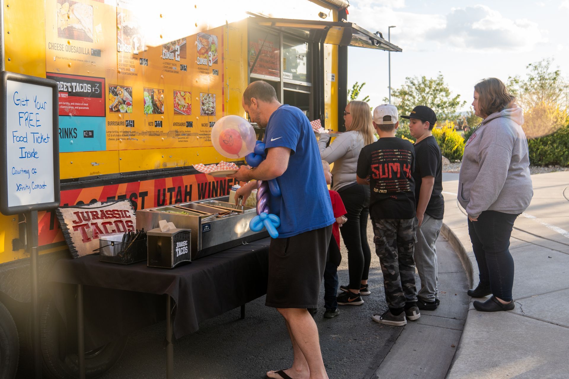 A group of people are standing in front of a food truck.