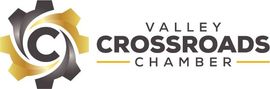 A logo for the valley crossroads chamber with a gear in the middle.