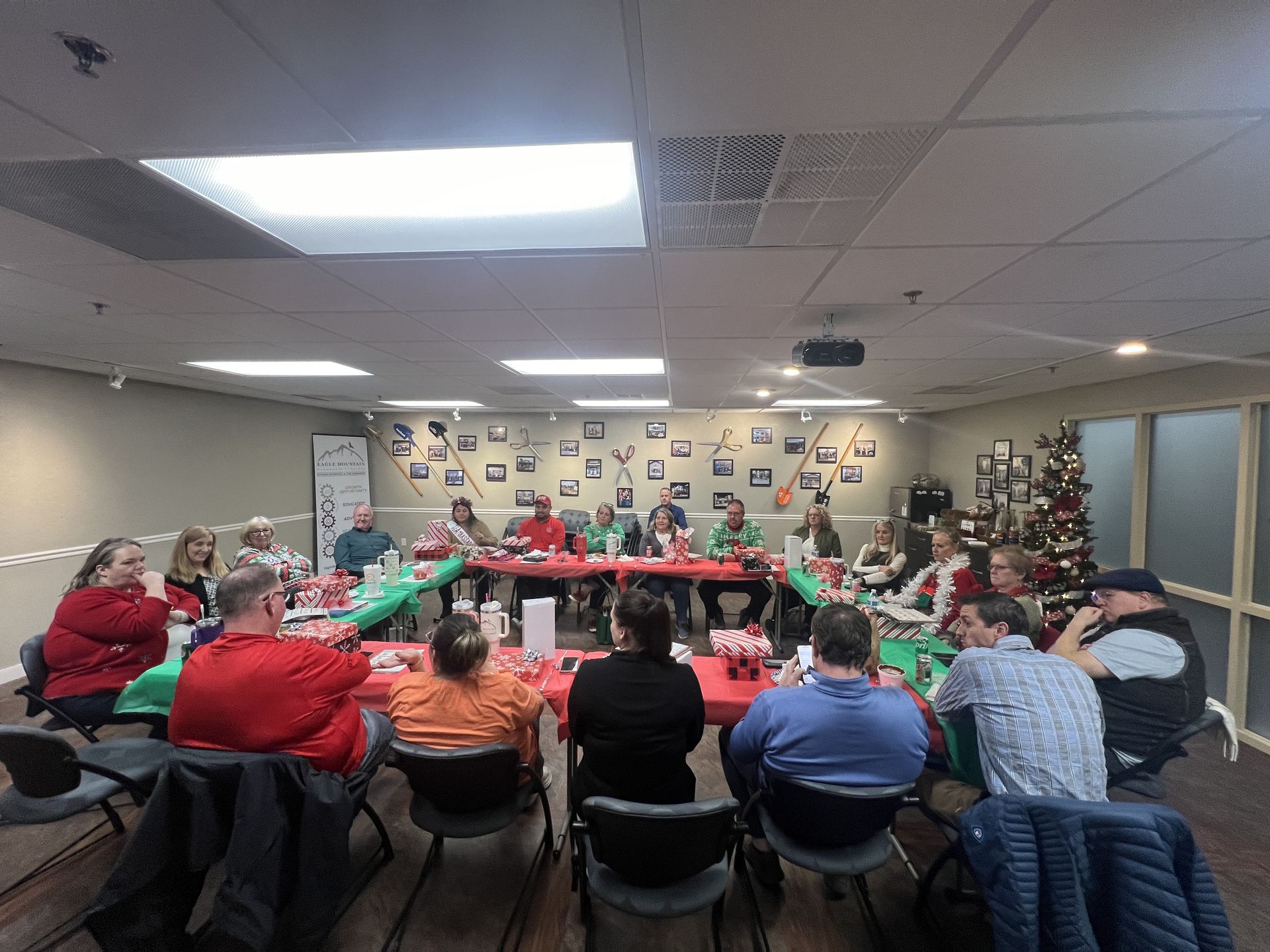 A group of people are sitting around a table in a room.