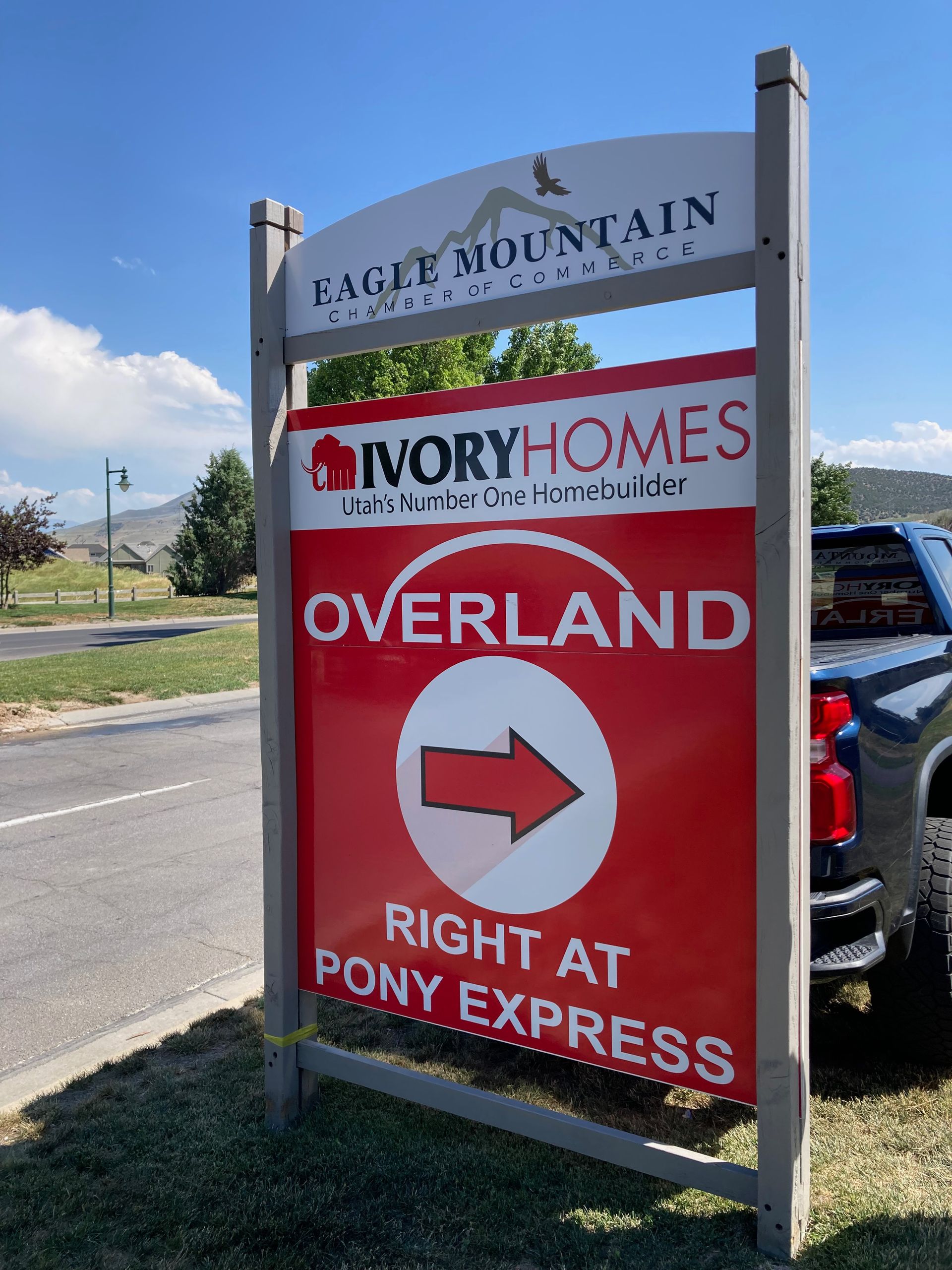 A sign that says ivory homes overland right at pony express