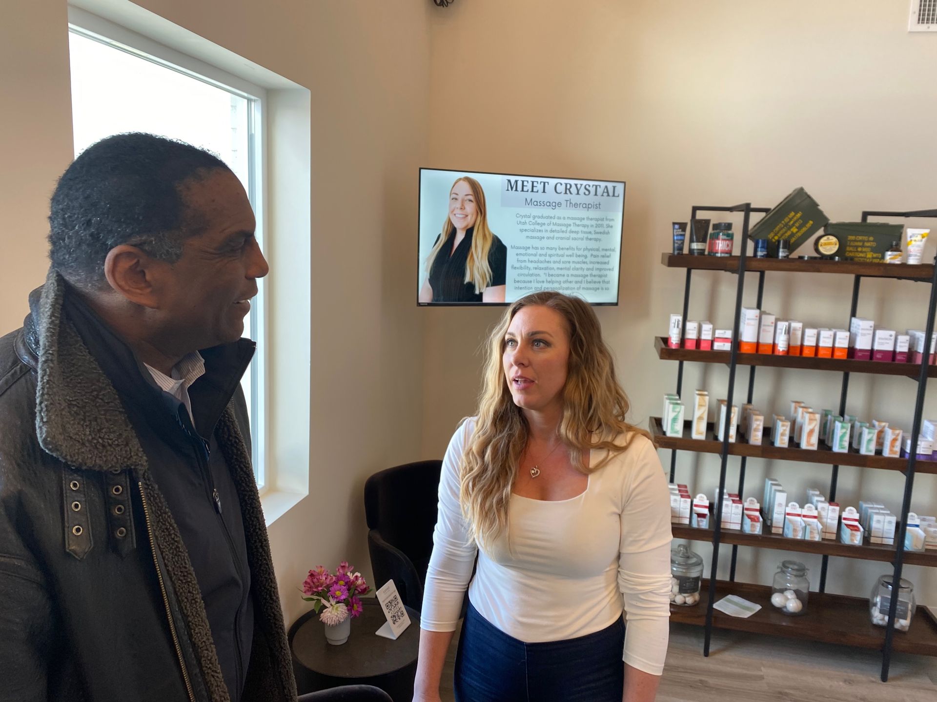 A man and a woman are standing next to each other in a room.