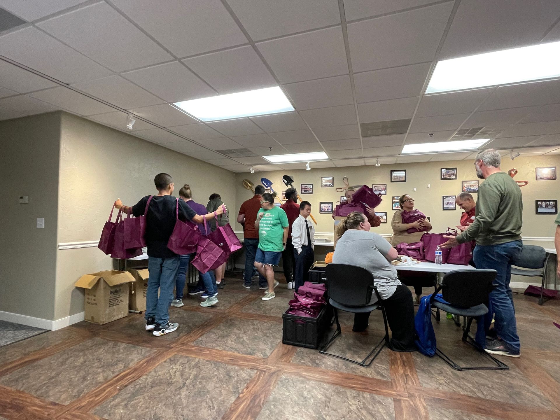 A group of people are standing around a table in a room.
