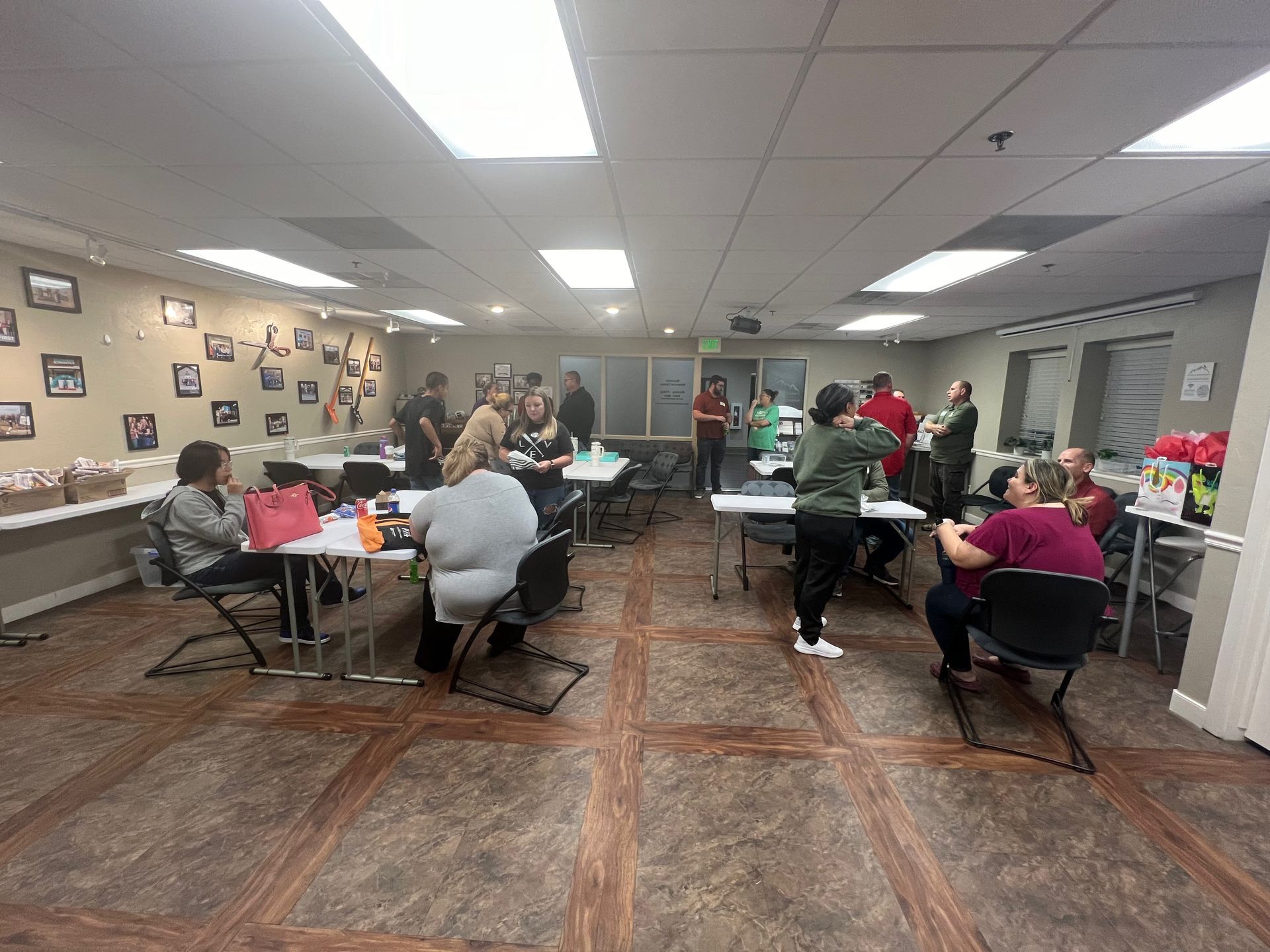 A group of people are sitting at tables in a large room.