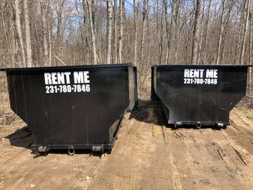 Two black dumpsters with