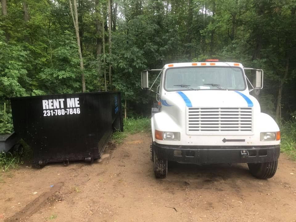Black dumpster labeled 