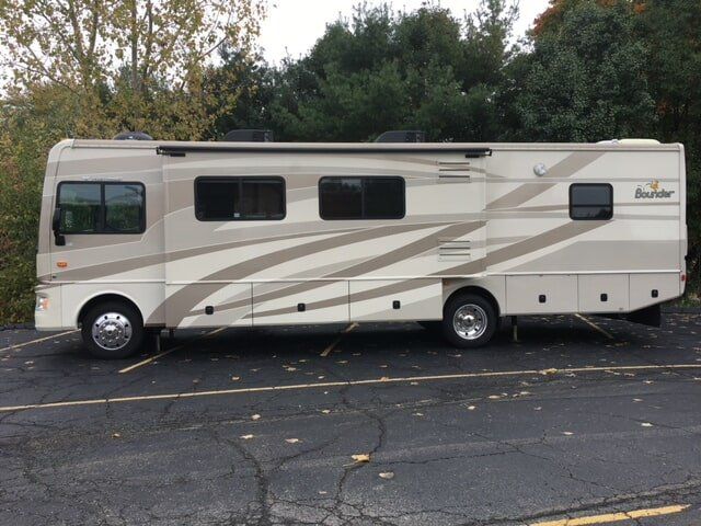 A large rv is parked in a parking lot