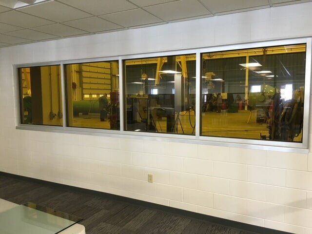 A room with a lot of windows and a table