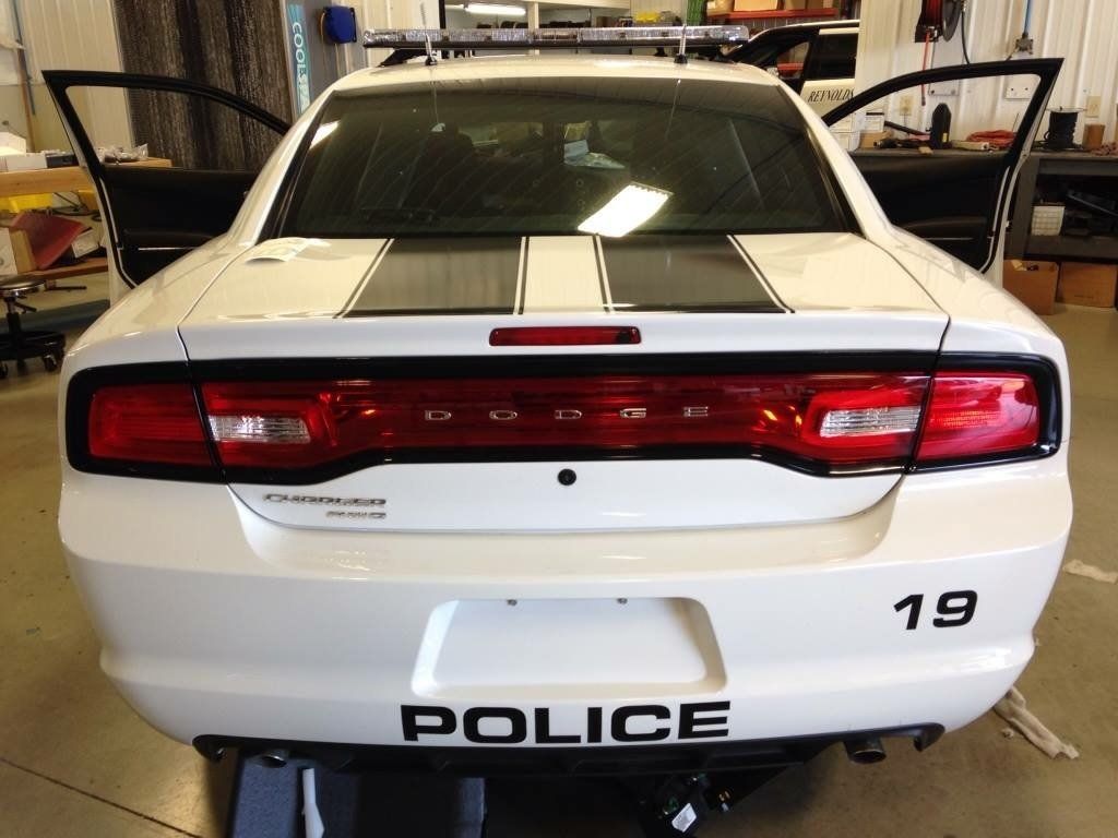 A white police car with the number 19 on the back