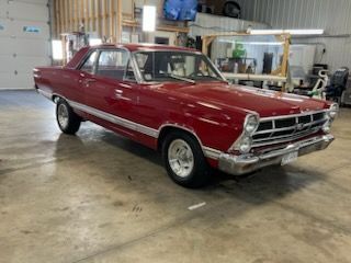 A red car is parked in a garage.