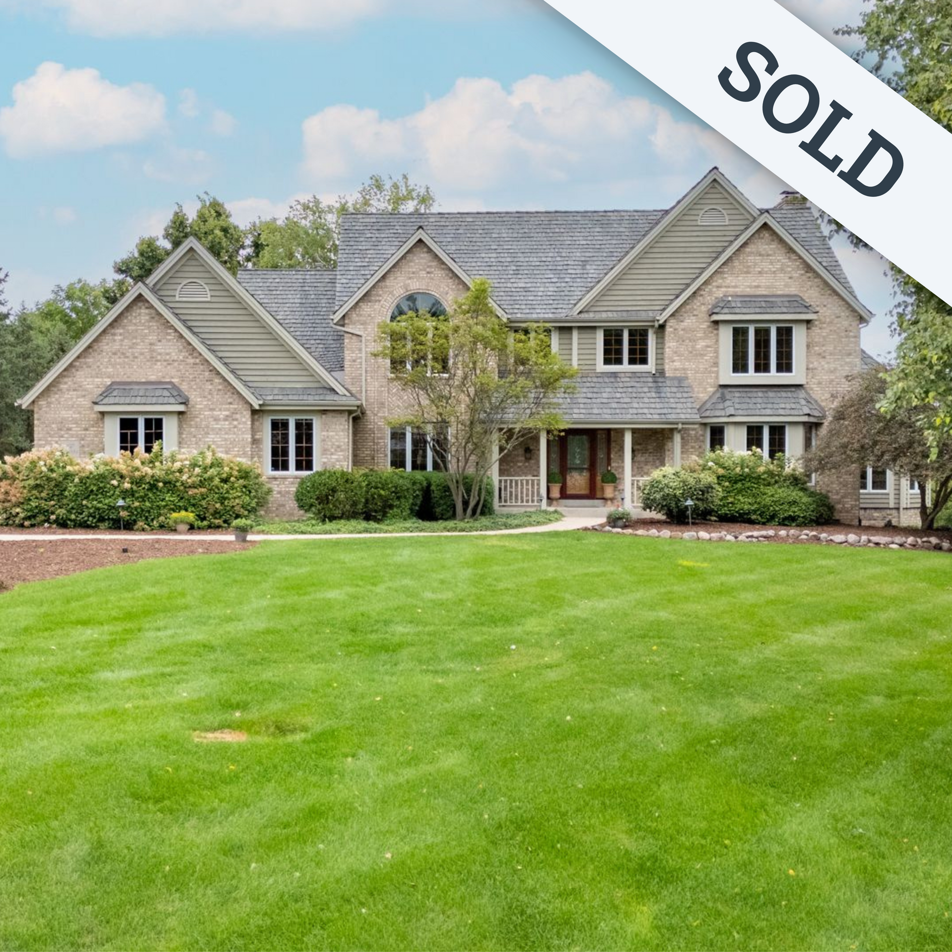 A large house with a large lawn in front of it