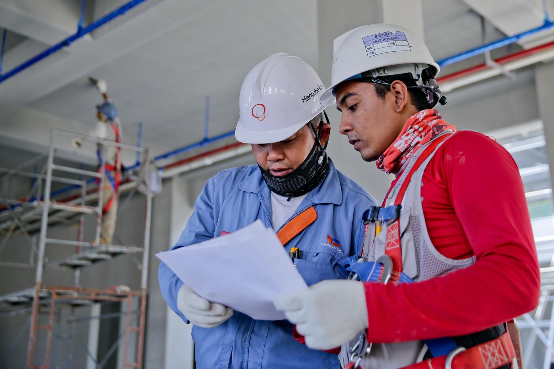 construction workers looking plans