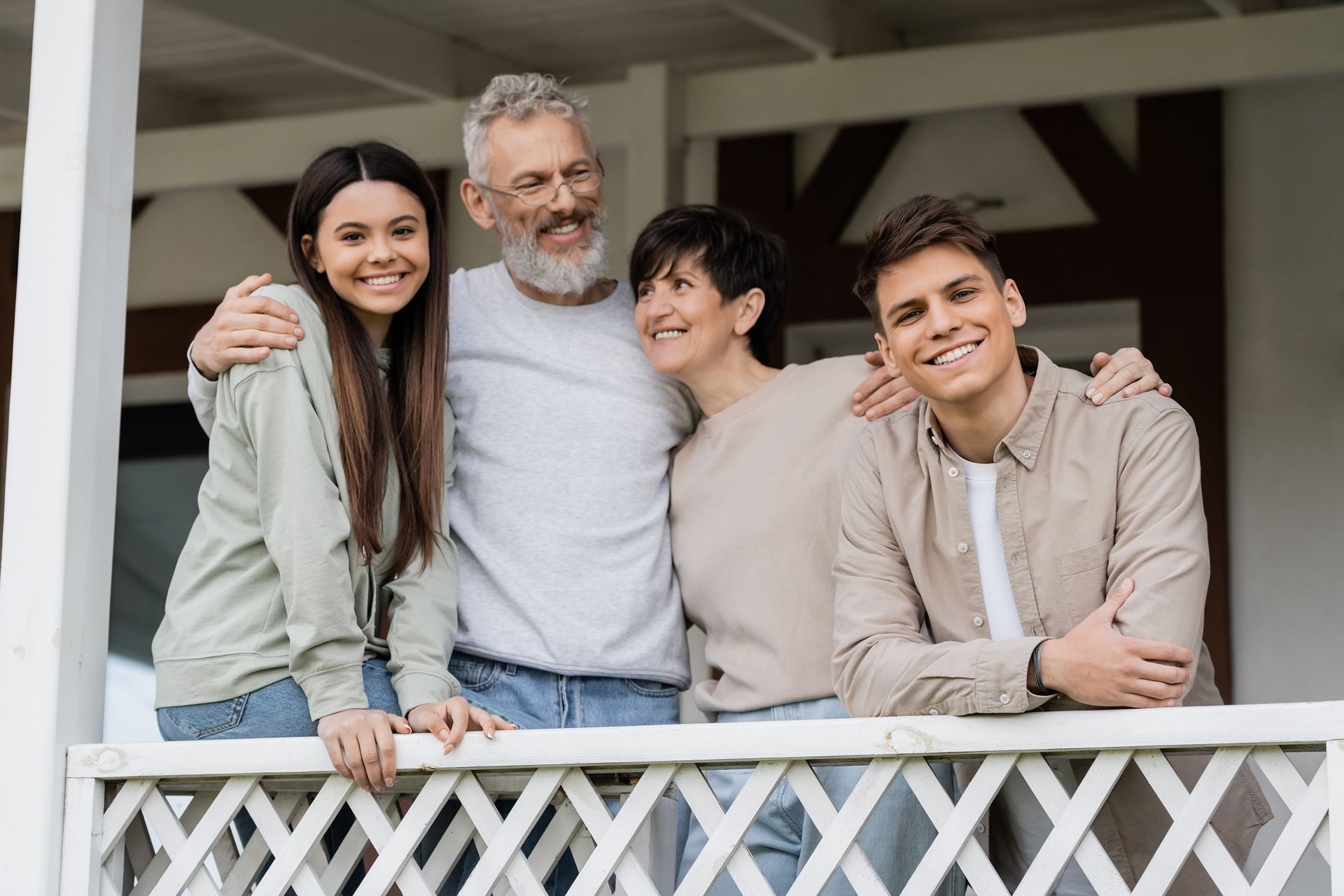 family picture for Illustration of death benefit payout. A family is posing for a picture on a porch. Illustration of death benefit payout