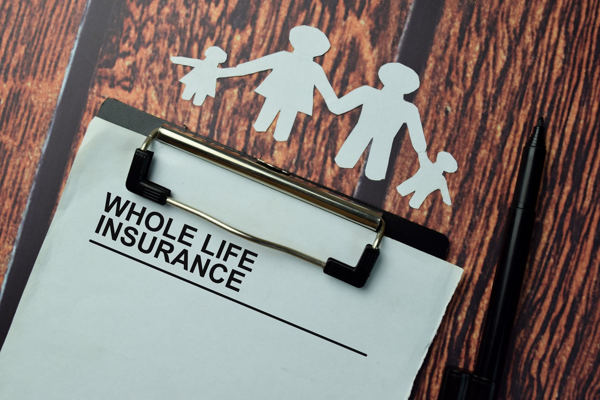 Illustration of a family with financial security A clipboard with a whole life insurance form on it for the Illustration of a family with financial security