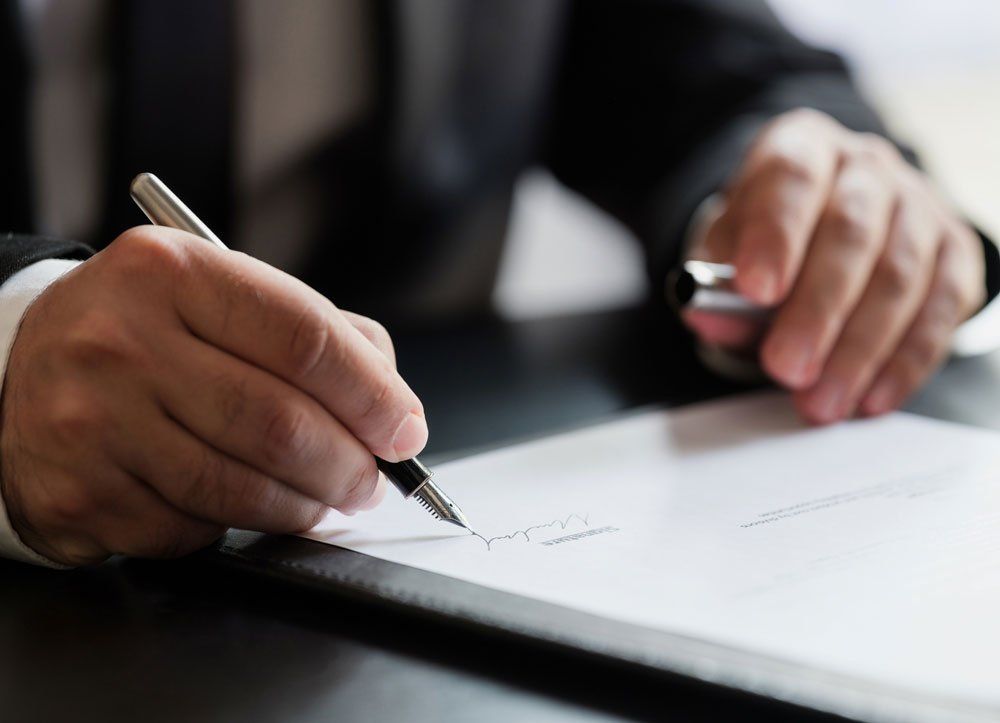 Man Signing A Document — Oakland, CA — Same Day Attorney Service Man Signing A Document — Oakland, CA — Same Day Attorney Service