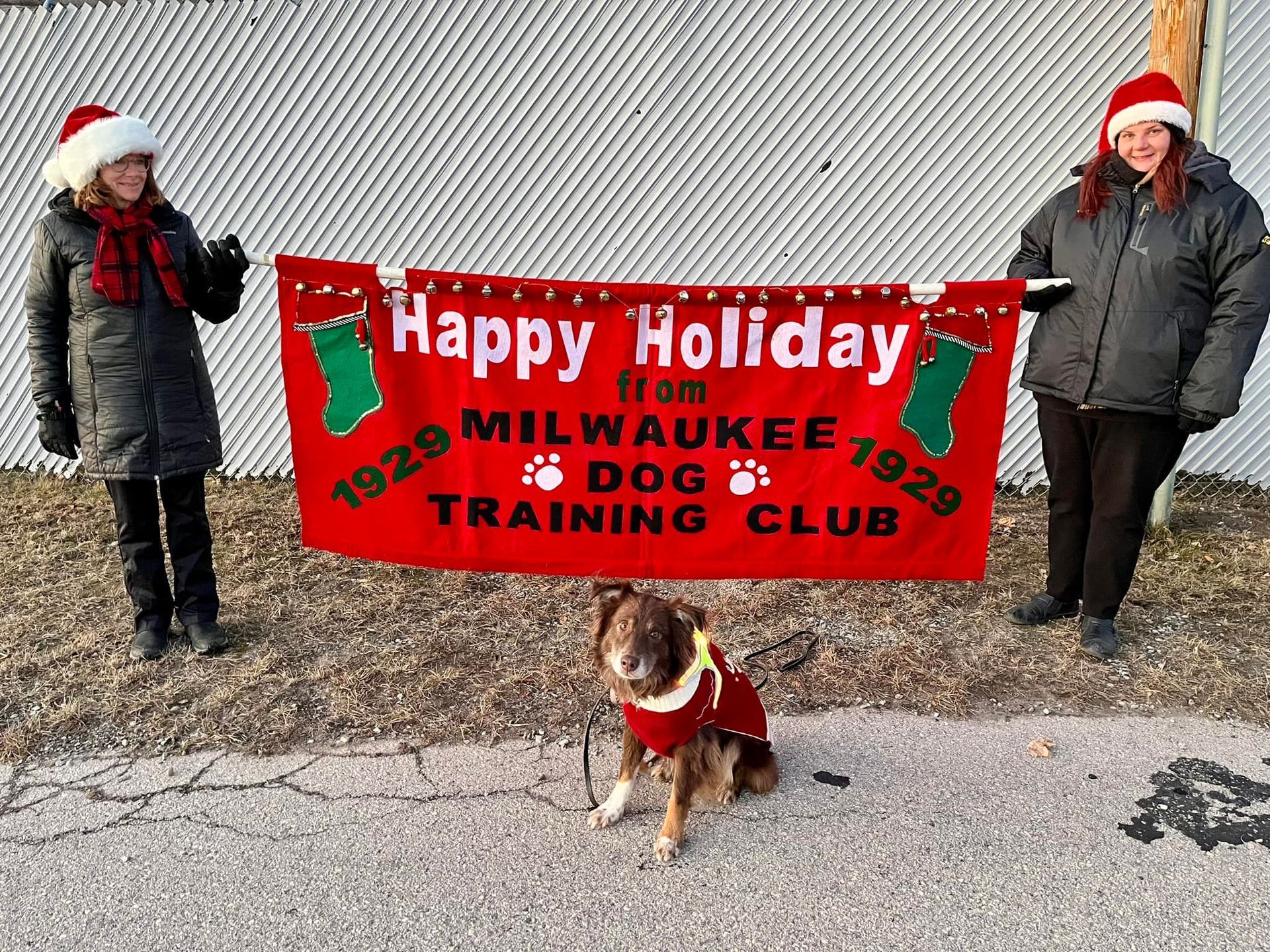 Two women and a dog pose with a 