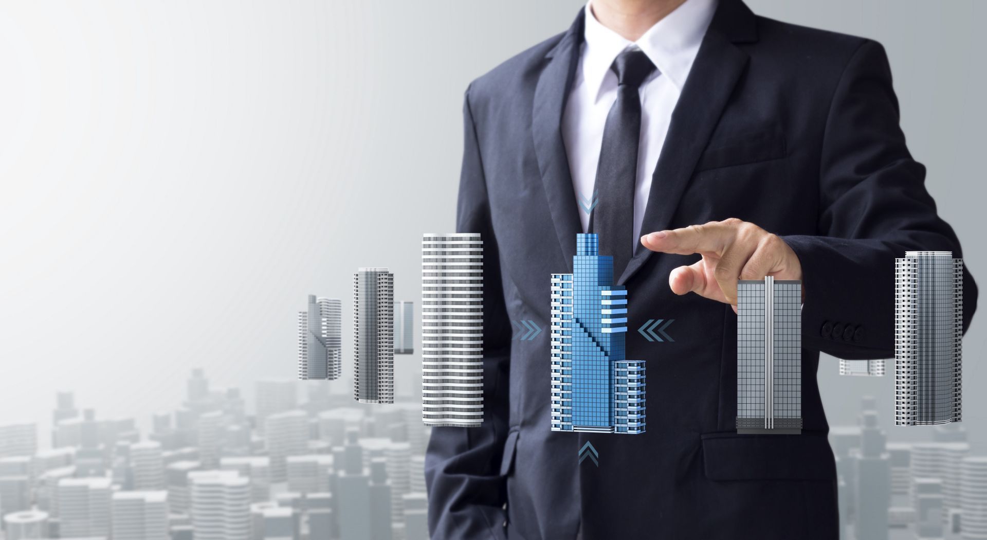 Businessman in a suit gesturing at blue digital buildings over a gray city skyline