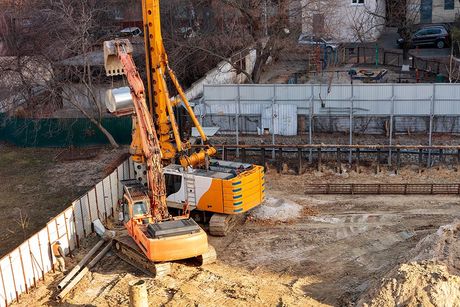 a construction site with a crane in the middle of it