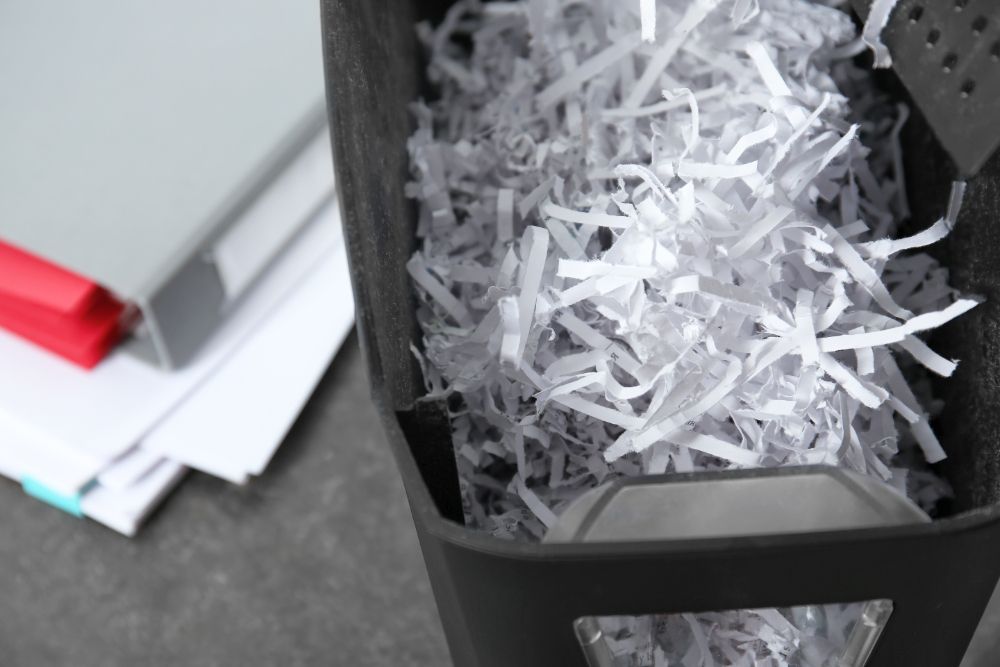 A pile of shredded paper is in a shredding machine.