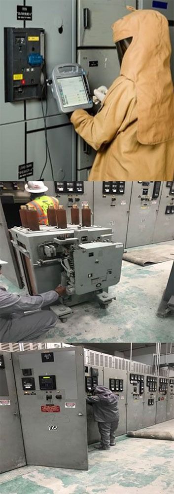 Worker in beige protective suit operating industrial control panel in a factory, with machinery and cabinets nearby