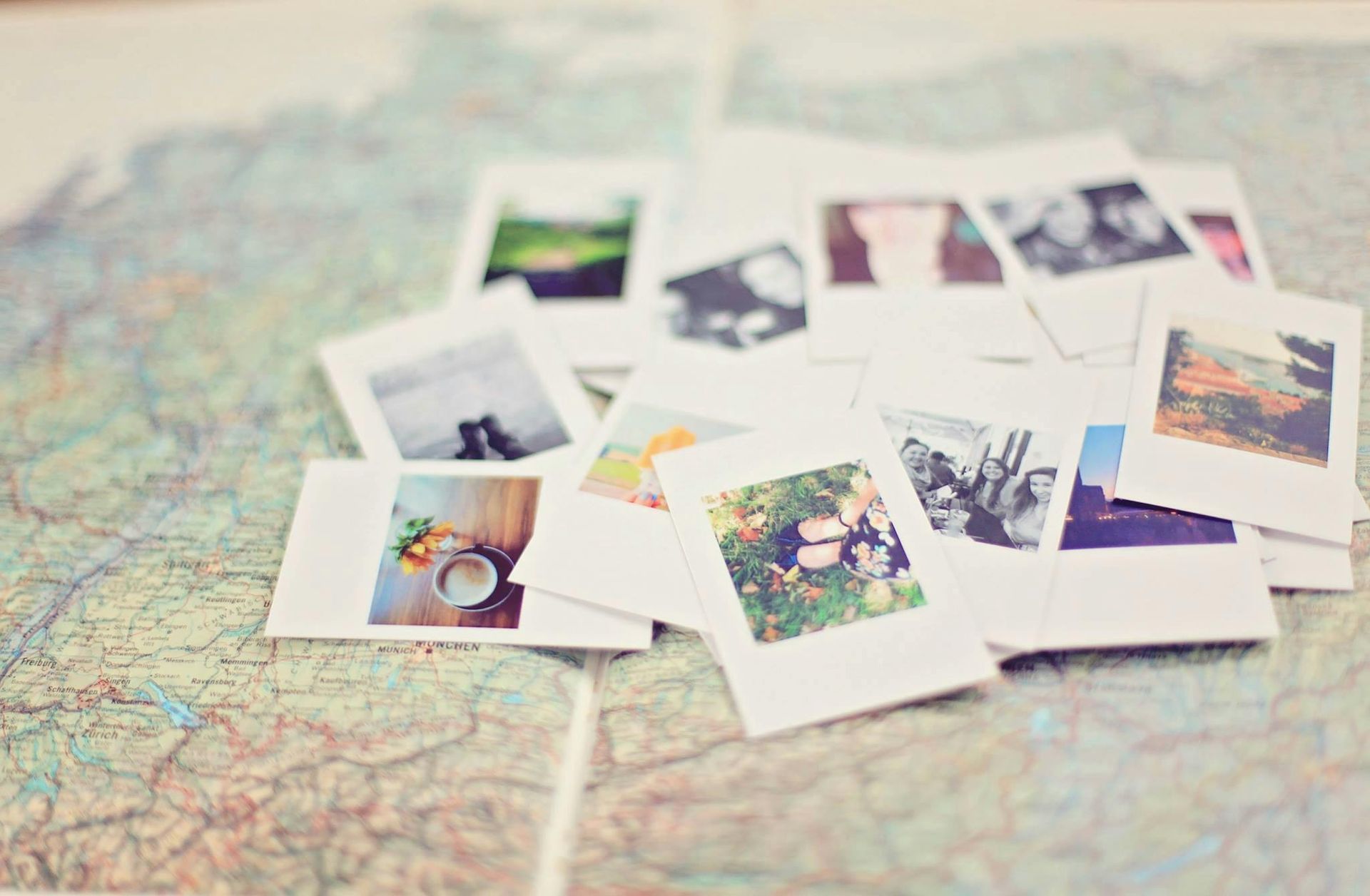 Polaroid photos scattered on a detailed map, capturing travel memories.