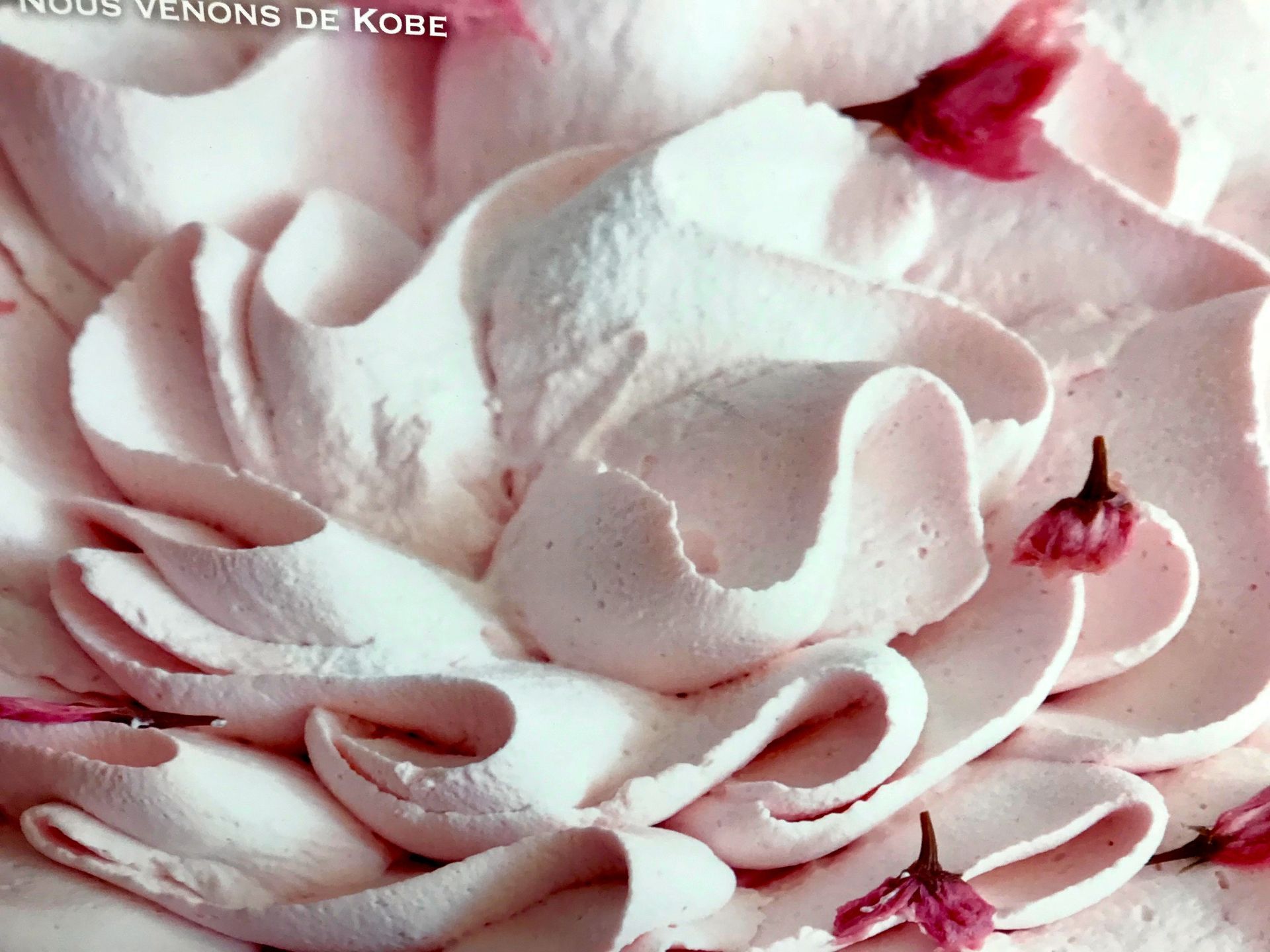creamy cake decoration with edible sakura flowers