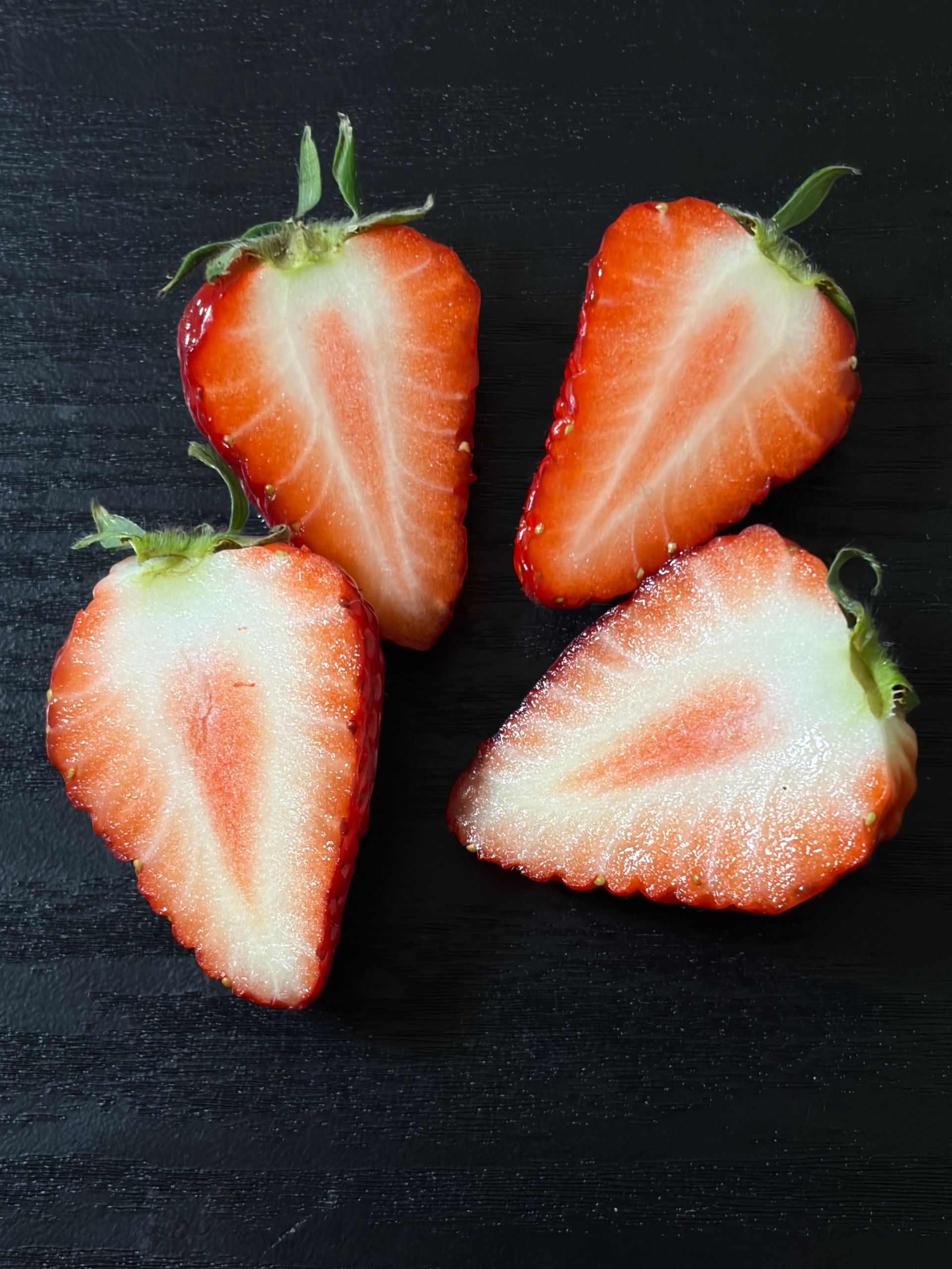 strawberries cut open with whitish flesh inside