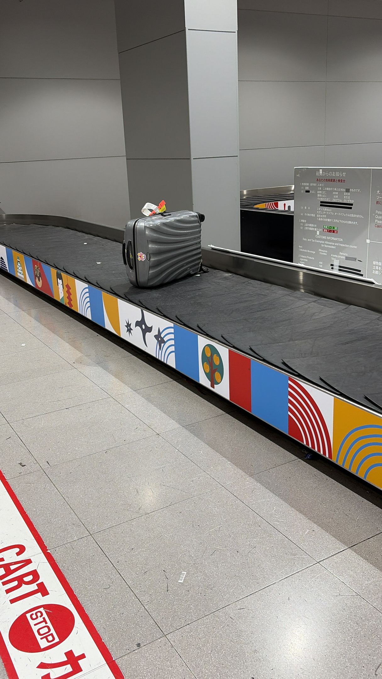 single suitcase on luggage belt at airport